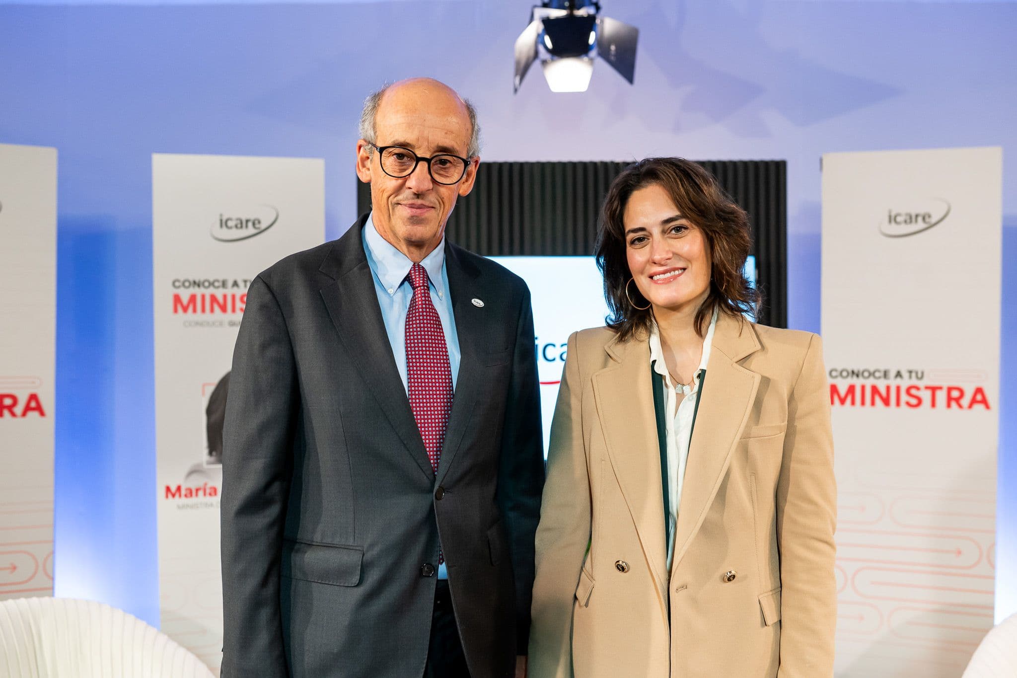 A man in a suit and woman in a blazer smiling at a 'Know Your Minister' event.