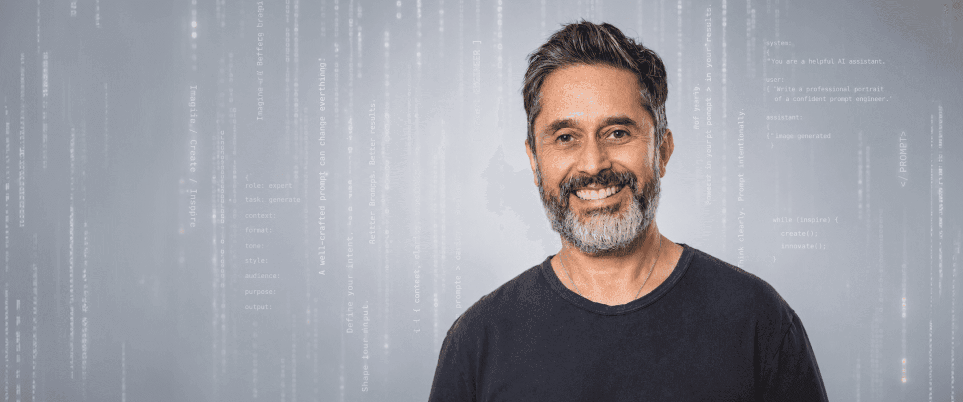 Smiling man with dark hair and beard in a black shirt, digital background.